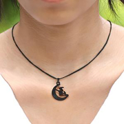 Black necklace with a moon pendant featuring a witch on a broomstick, black