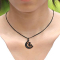 Black necklace with a moon pendant featuring a witch on a broomstick, black