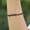 Black wave-patterned bracelet made of narra wood