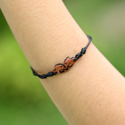 Black bracelet with two dolphins made of sawo wood