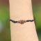 Black bracelet with two hearts made of sawo wood