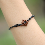 Black bracelet with a flower and black onyx stone made of...