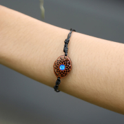 Black oval flower bracelet with blue opal made of sawo wood