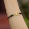 Black bracelet with gold-plated spider pendant