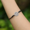 Black bracelet with silver mandala pendant