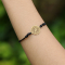 Black bracelet with gold-plated mandala pendant