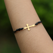 Black bracelet with gold-plated cross pendant