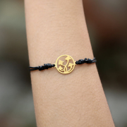 Black bracelet with gold-plated mushroom charms