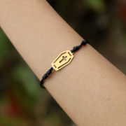 Black bracelet with gold-plated coffin pendant